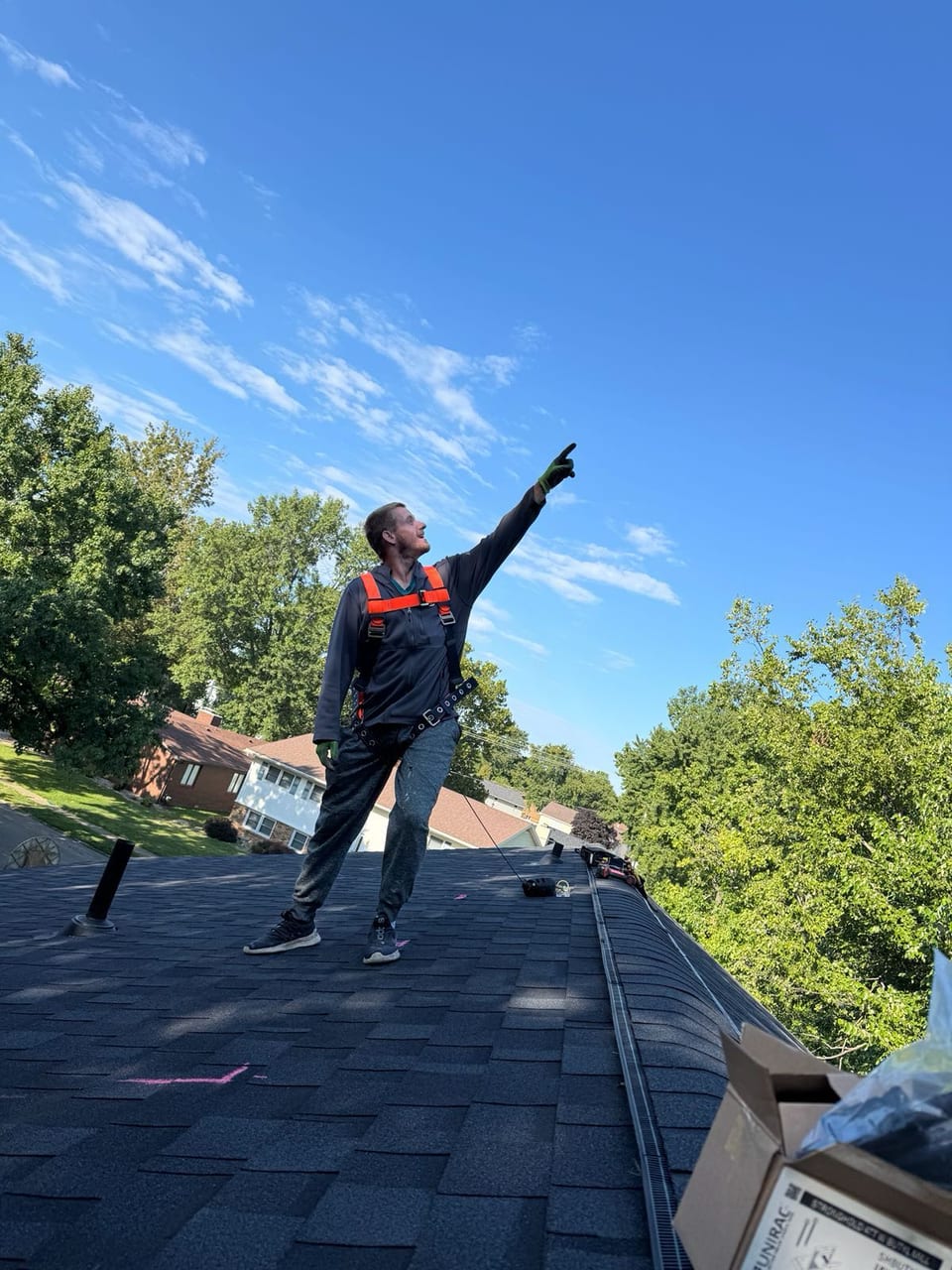 ETW Energy installer standing on a rooftop beside a completed solar array