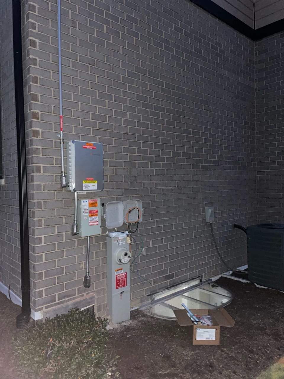 Electrical conduit and disconnect installed on a brick exterior wall