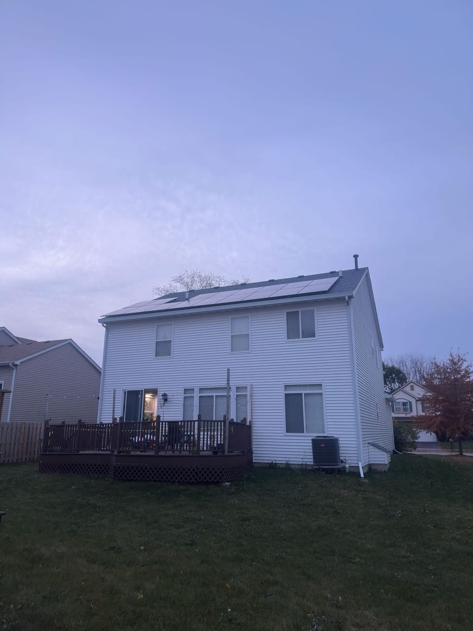 Home exterior at dusk after a completed solar installation
