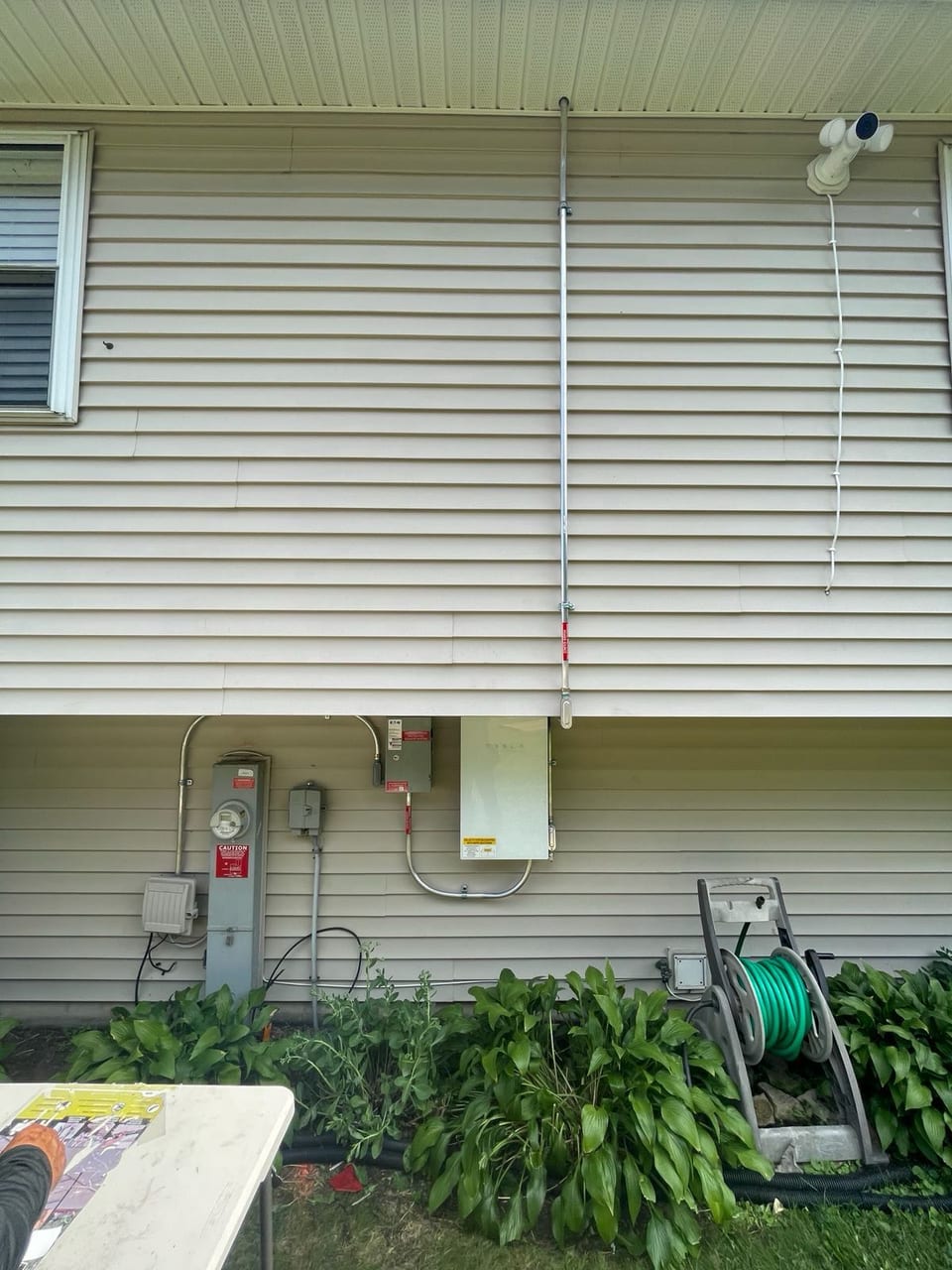 Solar electrical equipment mounted on a home exterior siding
