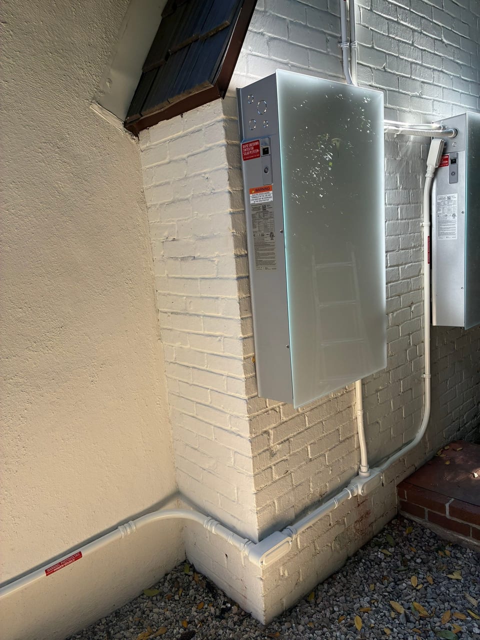 Metal electrical enclosure installed on a stucco exterior wall