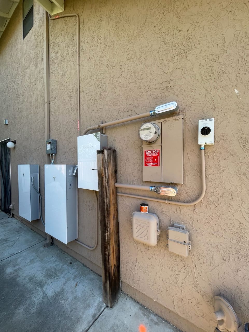 Solar electrical equipment and conduit on a stucco exterior wall
