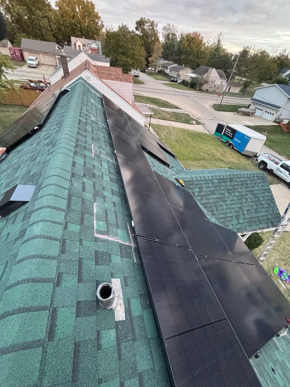 Solar panels running the length of a residential roof ridge