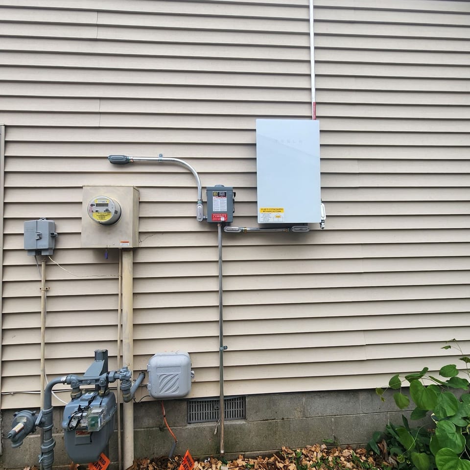 Solar electrical equipment and conduit run along a home exterior