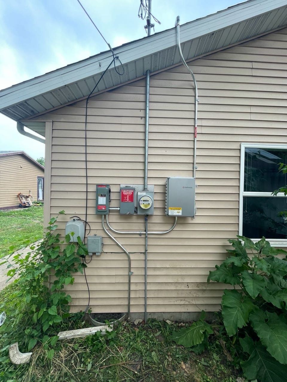 Solar electrical equipment installed on the side of a home