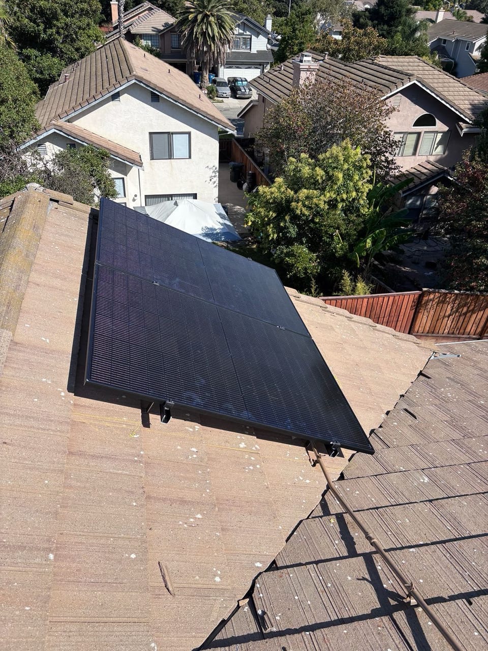Solar array on a residential roof overlooking neighboring homes