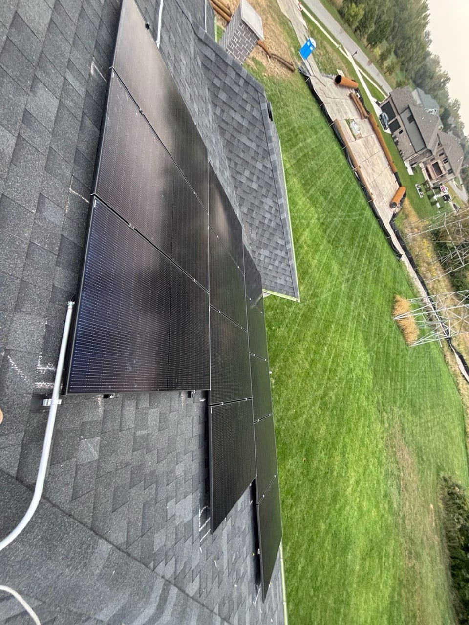 Solar panel array running down a residential roof slope