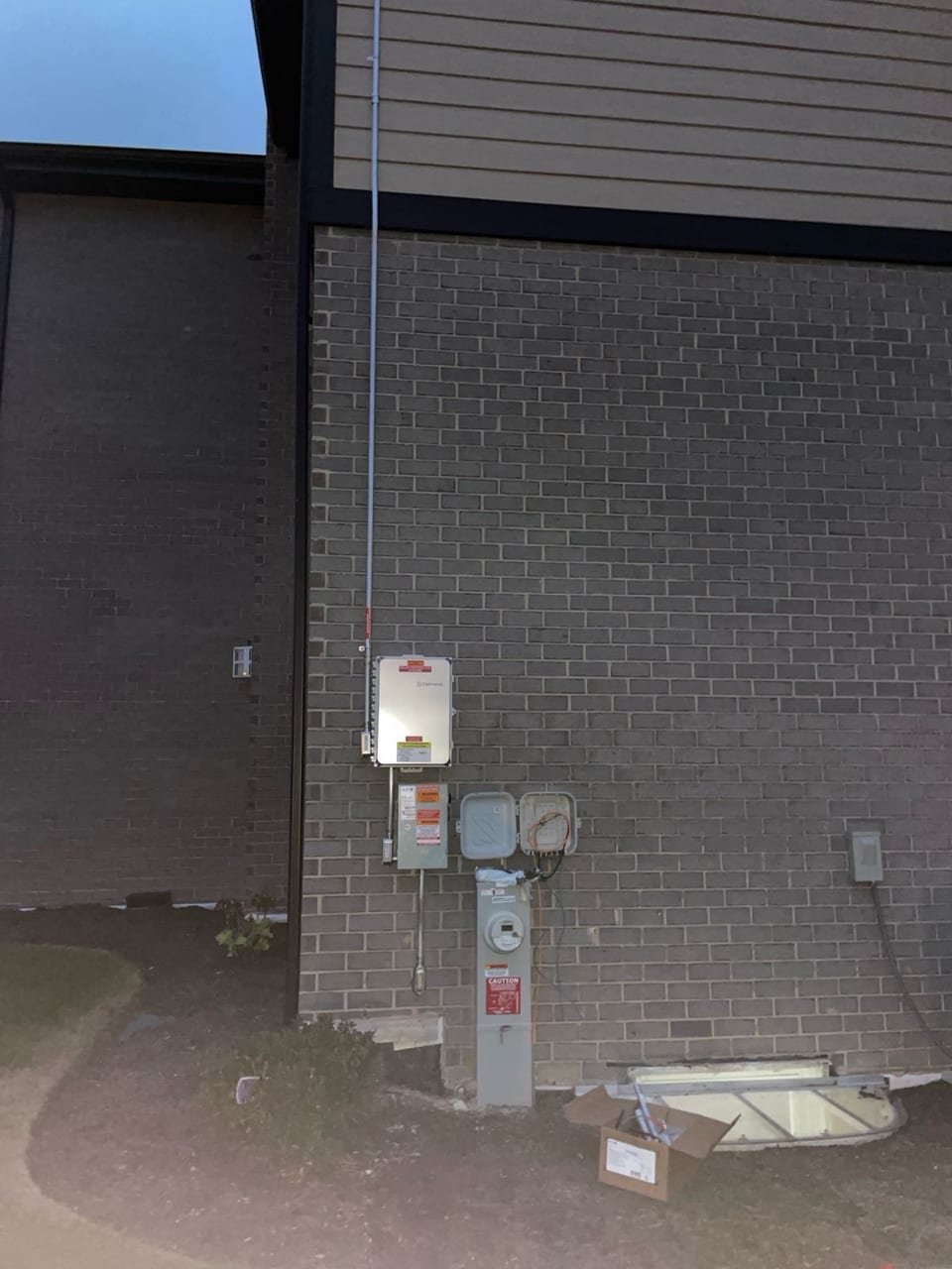 Solar electrical equipment installed on a dark exterior wall