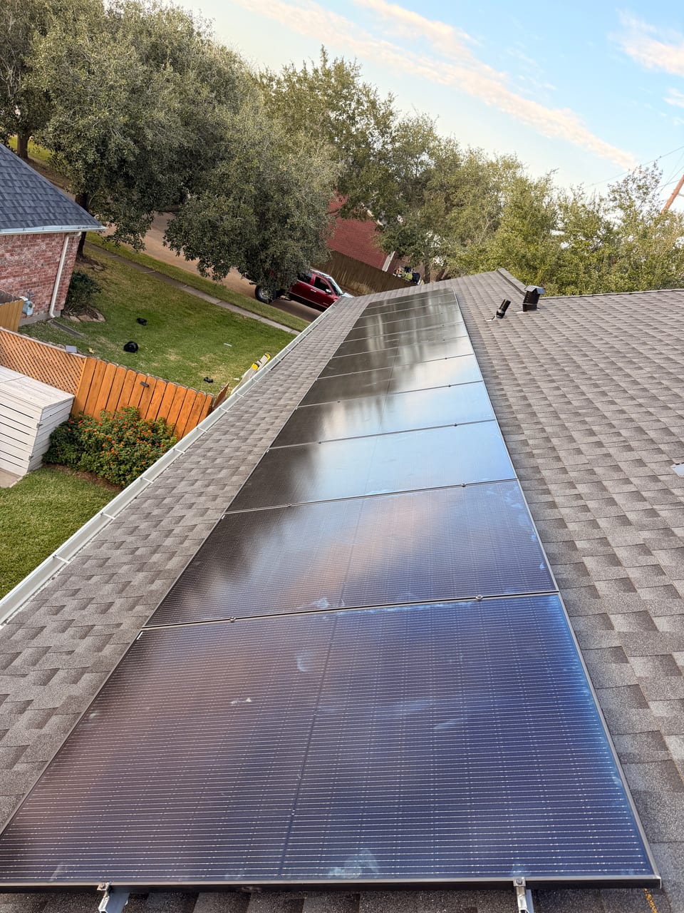 Solar array along a roof ridge at golden hour