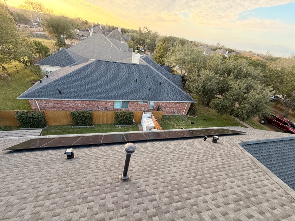 Brick home with a rooftop solar array at golden hour